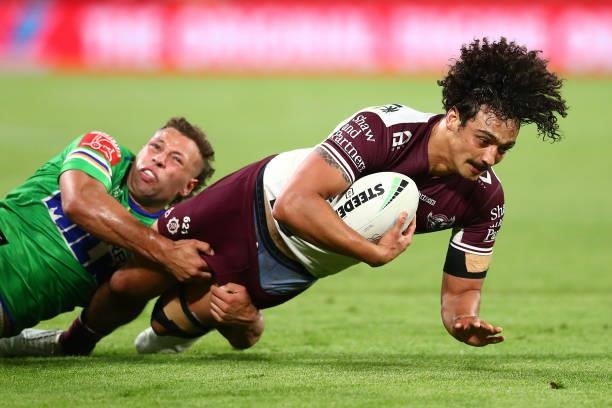 Morgan Harper of the Sea Eagles is tackled during the round 23 NRL match between the Canberra Raiders and the Manly Sea Eagles at Suncorp Stadium, on...