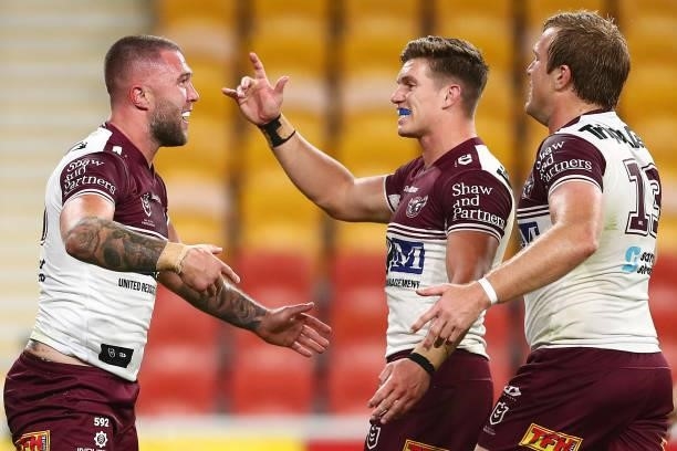Curtis Sironen of the Sea Eagles celebrates scoring a try with team mates during the round 23 NRL match between the Canberra Raiders and the Manly...