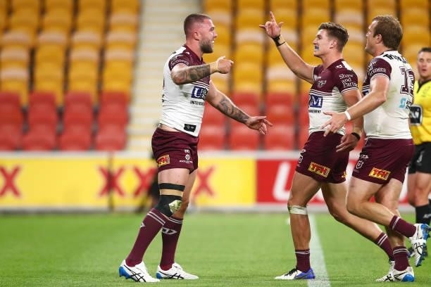 Curtis Sironen of the Sea Eagles celebrates scoring a try with team mates during the round 23 NRL match between the Canberra Raiders and the Manly...