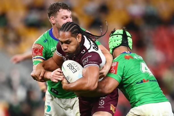 Martin Taupau of the Sea Eagles is tackled during the round 23 NRL match between the Canberra Raiders and the Manly Sea Eagles at Suncorp Stadium, on...