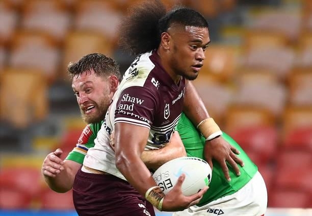 Moses Suli of the Sea Eagles is tackled during the round 23 NRL match between the Canberra Raiders and the Manly Sea Eagles at Suncorp Stadium, on...