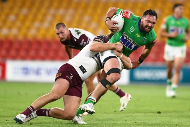 Jordan Rapana of the Raiders is tackled by Jake Trbojevic of the Sea Eagles during the round 23 NRL match between the Canberra Raiders and the Manly...