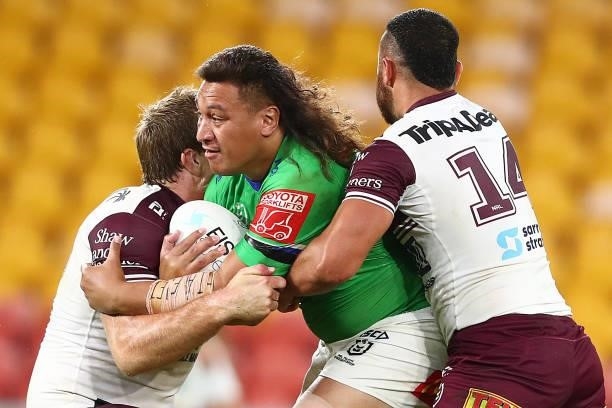 Josh Papalii of the Raiders is tackled during the round 23 NRL match between the Canberra Raiders and the Manly Sea Eagles at Suncorp Stadium, on...
