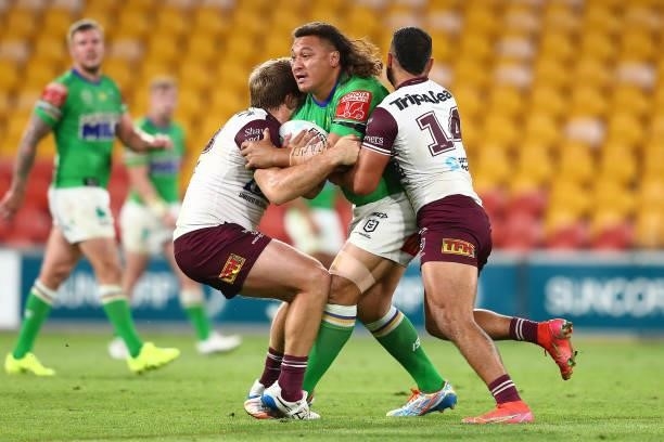 Josh Papalii of the Raiders is tackled during the round 23 NRL match between the Canberra Raiders and the Manly Sea Eagles at Suncorp Stadium, on...