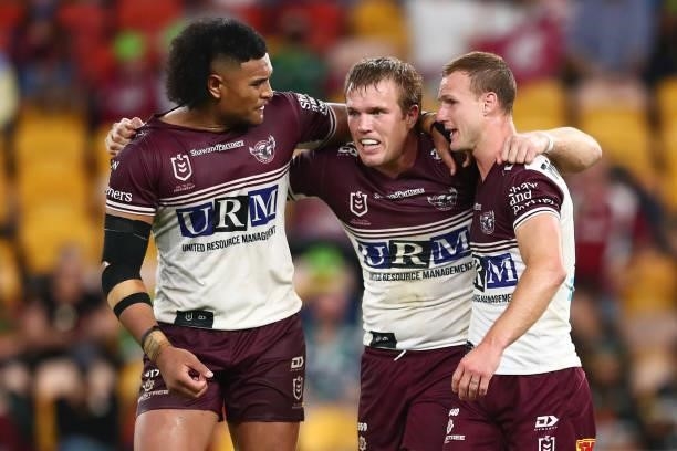 Haumole Olakau'atu, Daly Cherry-Evans and Jake Trbojevic of the Sea Eagles celebrate after victory during the round 23 NRL match between the Canberra...