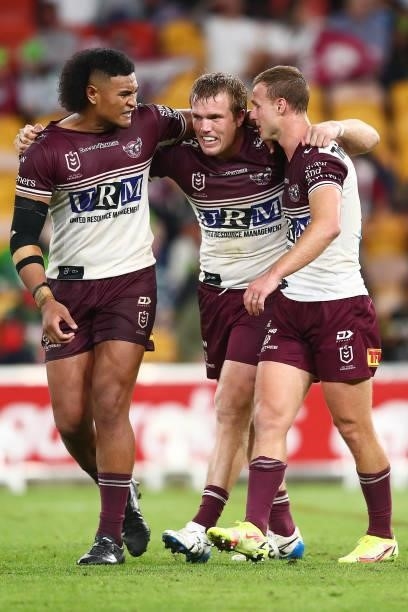 Haumole Olakau'atu, Daly Cherry-Evans and Jake Trbojevic of the Sea Eagles celebrate after victory during the round 23 NRL match between the Canberra...