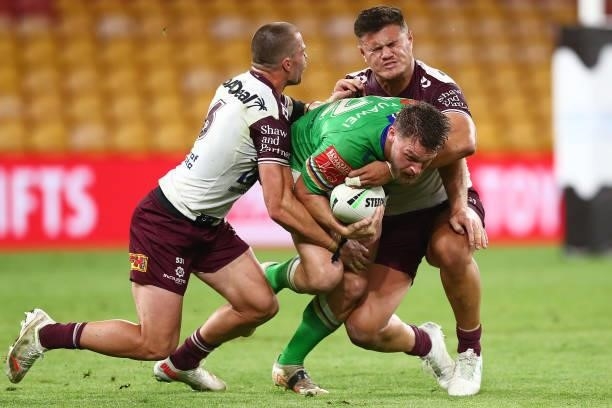 Elliott Whitehead of the Raiders is tackled during the round 23 NRL match between the Canberra Raiders and the Manly Sea Eagles at Suncorp Stadium,...
