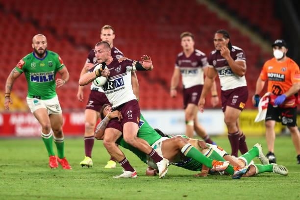 Kieran Foran of the Sea Eagles is tackled by Josh Papalii of the Raiders during the round 23 NRL match between the Canberra Raiders and the Manly Sea...