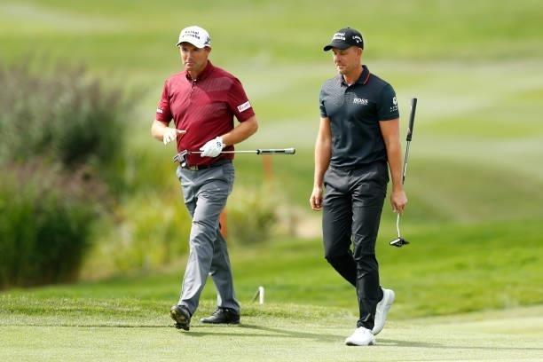 Padraig Harrington of Ireland speaks with Henrik Stenson of Sweden on the ninth hole during Day Two of The D+D Real Czech Masters at Albatross Golf...