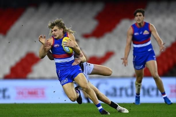 Bailey Smith of the Bulldogs is tackled by Willem Drew of the Power during the round 23 AFL match between Western Bulldogs and Port Adelaide Power at...
