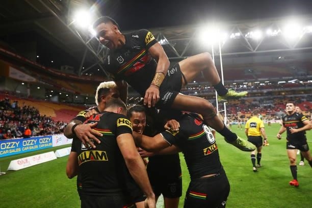 Stephen Crichton of the Panthers jumps to celebrate a try by Brent Naden of the Panthers with team mates during the round 23 NRL match between the...