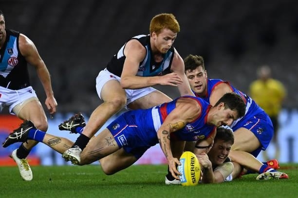 Tom Liberatore of the Bulldogs is tackled by Willem Drew of the Power during the round 23 AFL match between Western Bulldogs and Port Adelaide Power...