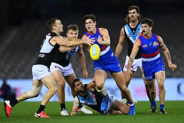 Lewis Young of the Bulldogs handballs during the round 23 AFL match between Western Bulldogs and Port Adelaide Power at Marvel Stadium on August 20,...