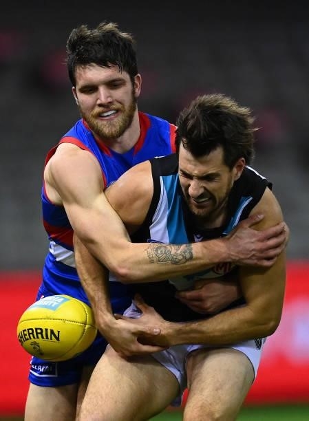 Sam Mayes of the Power is tackled by Bailey Williams of the Bulldogs during the round 23 AFL match between Western Bulldogs and Port Adelaide Power...