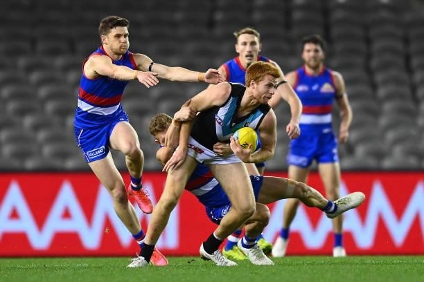 Willem Drew of the Power is tackled by Adam Treloar of the Bulldogs during the round 23 AFL match between Western Bulldogs and Port Adelaide Power at...