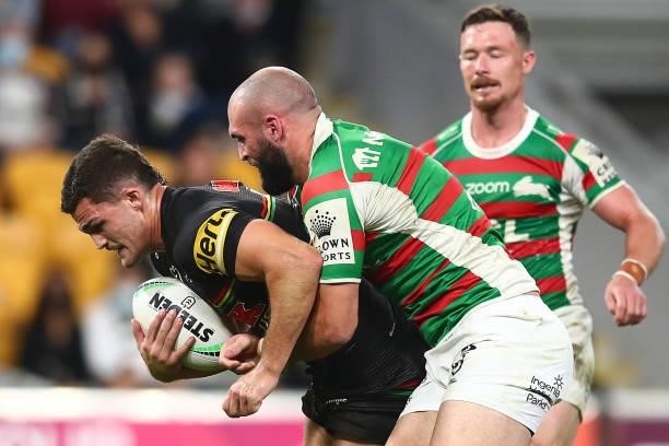 Nathan Cleary of the Panthers is tackled by Mark Nicholls of the Rabbitohs during the round 23 NRL match between the Penrith Panthers and the South...