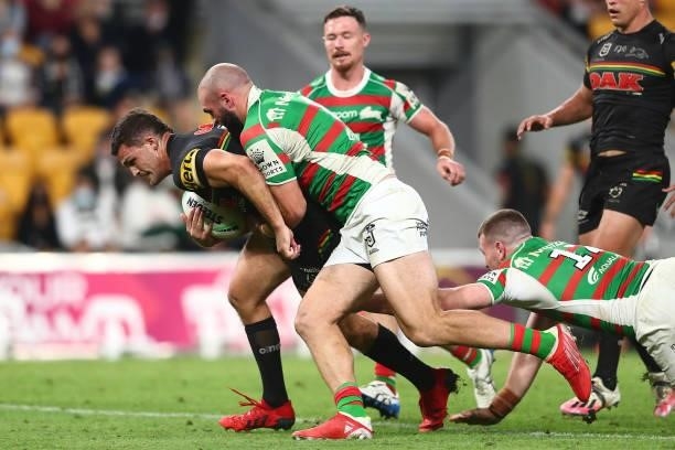 Nathan Cleary of the Panthers is tackled by Mark Nicholls of the Rabbitohs during the round 23 NRL match between the Penrith Panthers and the South...