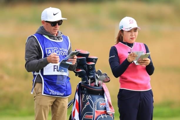 Ayaka Furue of Japan prepares to play a shot on the fourth hole with her caddie during Day Two of the AIG Women's Open at Carnoustie Golf Links on...