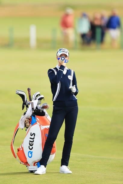 Nelly Korda of The United States takes a drink from an official AIG Women's Open Water Bottle as she waits to play her second shot on the sixth hole...
