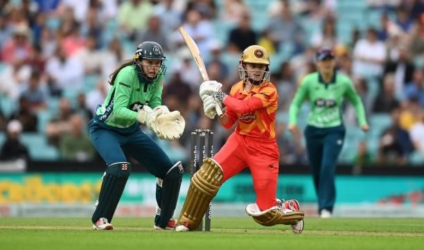 Gwen Davies of Birmingham Phoenix Women plays a shot as Sarah Bryce of Oval Invincibles Women looks on during the Eliminator match of The Hundred...