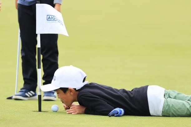 Young golf fan plays on the practice putting green in the Spectator Village during Day Two of the AIG Women's Open at Carnoustie Golf Links on August...