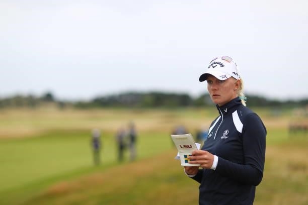Madelene Sagstrom of Sweden checks her pocket book as she prepares to play her second shot on the fifteenth hole during Day Two of the AIG Women's...