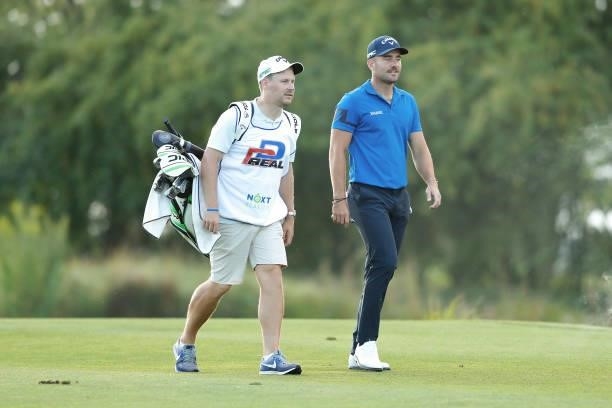 Toby Tree of England and his caddie make their way along the 18th hole during Day Two of The D+D Real Czech Masters at Albatross Golf Resort on...