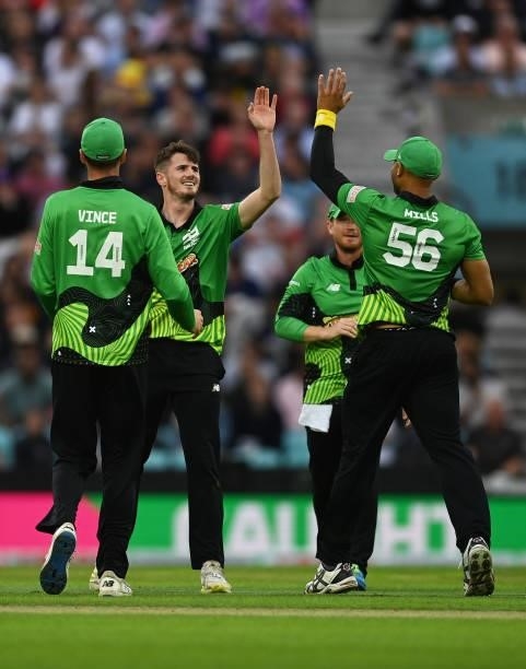 George Garton of Southern Brave Men celebrates after taking the wicket of D'Arcy Short of Trent Rockets Men with team mates James Vince and Tymal...