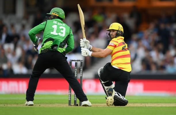 Rockets batter Lewis Gregory sweeps to the boundary watched by Quinton de Kock during the Eliminator match of The Hundred between Southern Brave Men...