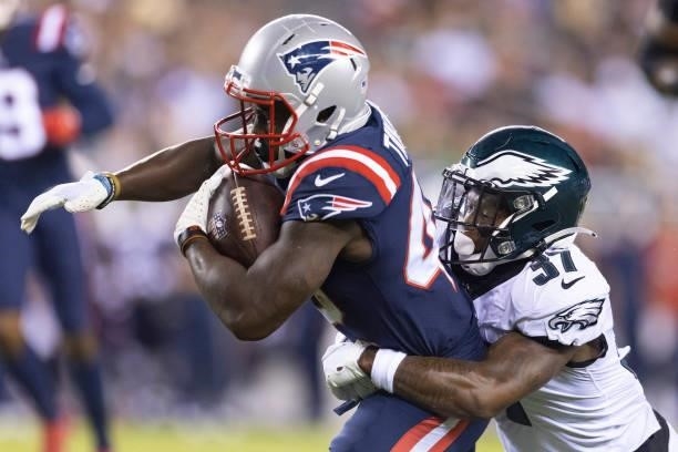 Grayland Arnold of the Philadelphia Eagles tackles J.J. Taylor of the New England Patriots in the preseason game at Lincoln Financial Field on August...