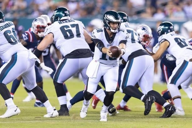 Nick Mullens of the Philadelphia Eagles drops back against the New England Patriots in the preseason game at Lincoln Financial Field on August 19,...