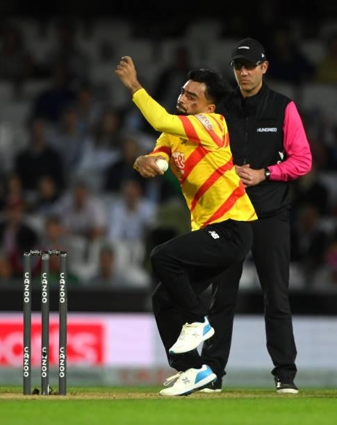 Rockets bowler Rashid Khan in bowling action with the colours of the Afghanistan flag painted on his face during the Eliminator match of The Hundred...