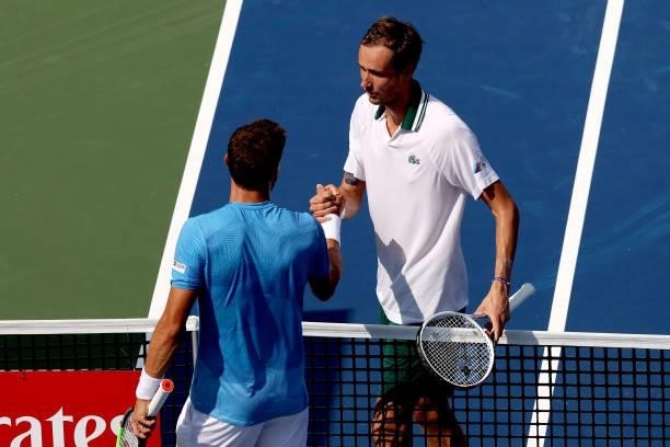 Pablo Carreno Busta of Spain congratulates Daniil Medvedev of Russia during the Western & Southern Open at Lindner Family Tennis Center on August 20,...