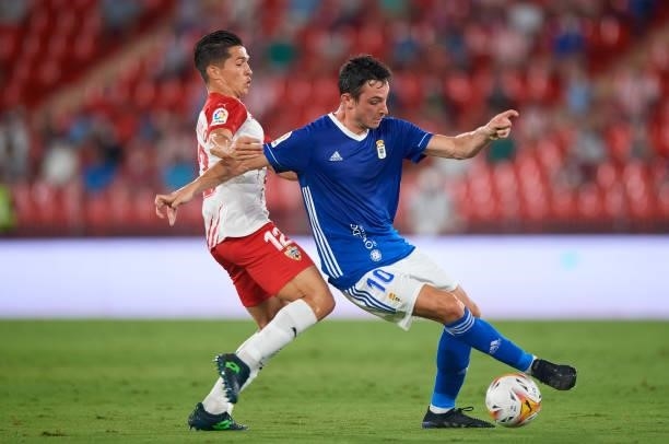 Juan Jose Nieto Zanzoso of UD Almeria competes for the ball with Borja Sanchez Laborde of Real Oviedo during the LaLiga Smartbank match between UD...