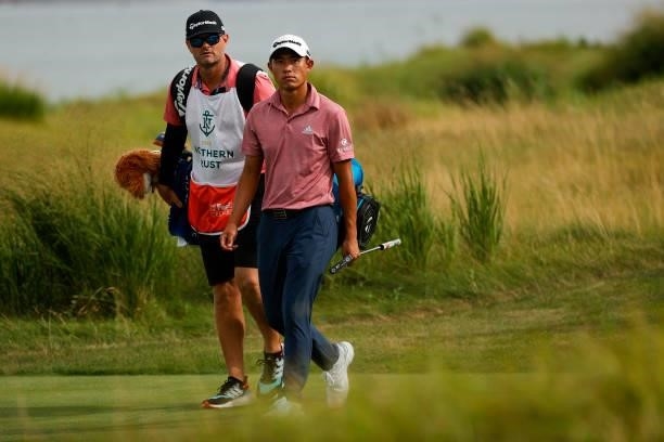 Collin Morikawa of the United States and caddie Jonathan Jakovac walk to the 14th green during the second round of THE NORTHERN TRUST, the first...