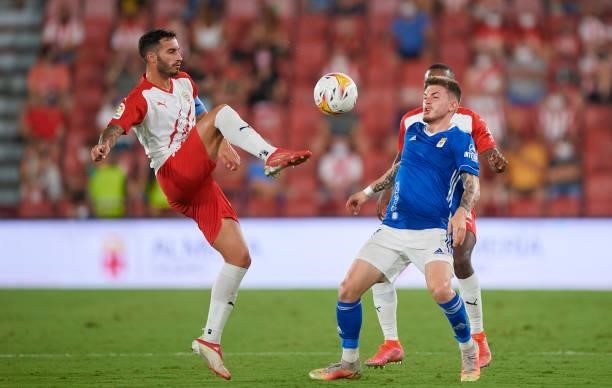 Jose Carlos Lazo Romero of UD Almeria competes for the ball with Victor Alvarez Rozada of Real Oviedo during the LaLiga Smartbank match between UD...