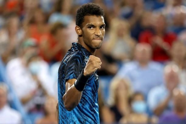 Felix Auger-Aliassime of Canada celebrates winning the second set against Stefanos Tsitsipas of Greece during the Western & Southern Open at Lindner...