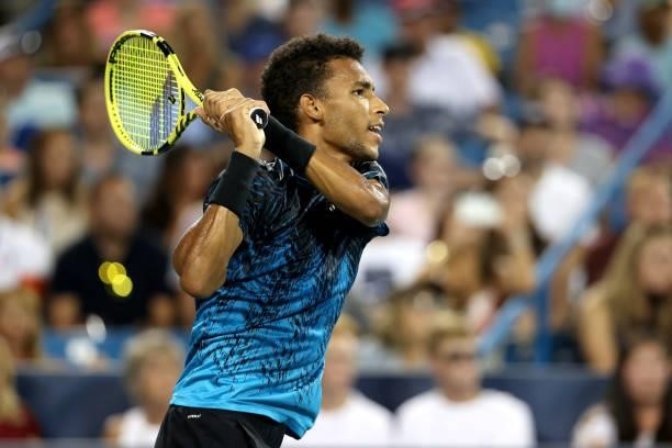 Felix Auger-Aliassime of Canada returns a shot to Stefanos Tsitsipas of Greece during the Western & Southern Open at Lindner Family Tennis Center on...