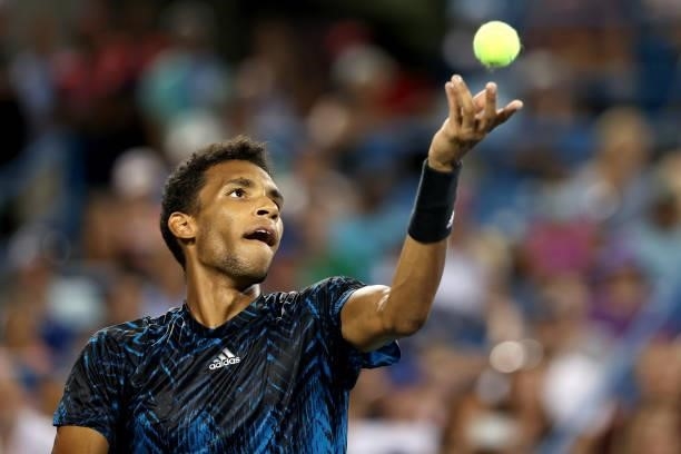 Felix Auger-Aliassime of Canada serves to Stefanos Tsitsipas of Greece during the Western & Southern Open at Lindner Family Tennis Center on August...