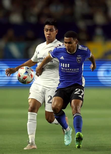 Efrain Alvarez of Los Angeles Galaxy and Marcos Lopez of San Jose Earthquakes in the first half at Dignity Health Sports Park on August 20, 2021 in...