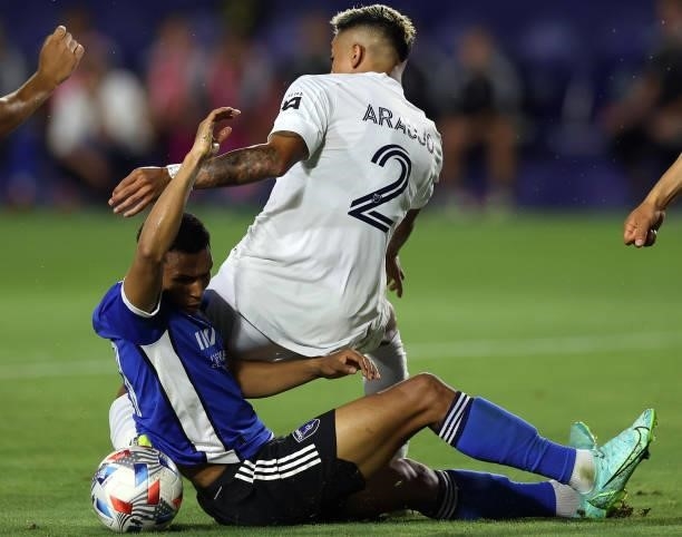 Julian Araujo of Los Angeles Galaxy and Marcos Lopez of San Jose Earthquakes in the first half at Dignity Health Sports Park on August 20, 2021 in...