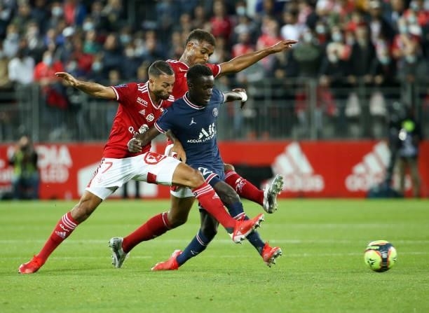 Idrissa Gueye Gana of PSG between Haris Belkebla, Steve Mounie of Brest during the Ligue 1 match between Stade Brestois 29 and Paris Saint-Germain at...