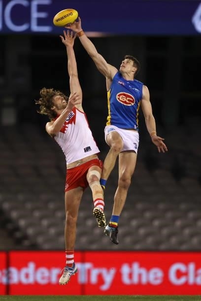 Tom Hickey of the Swans and Chris Burgess of the Suns contest the ball during the round 23 AFL match between Sydney Swans and Gold Coast Suns at...