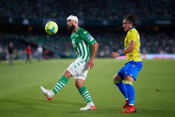 Nabil Fekir of Real Betis competes for the ball with Pacha Espino of Cadiz CF during the La Liga Santader match between Real Betis and Cadiz CF on...