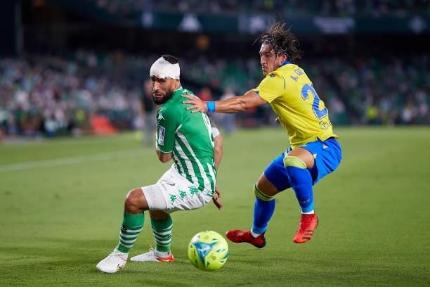 Nabil Fekir of Real Betis competes for the ball with Pacha Espino of Cadiz CF during the La Liga Santader match between Real Betis and Cadiz CF on...