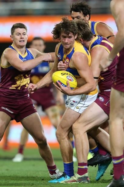 Connor West of the Eagles is tackled during the round 23 AFL match between Brisbane Lions and West Coast Eagles at The Gabba on August 21, 2021 in...