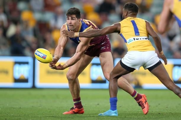 Marcus Adams of the Lions handballs during the round 23 AFL match between Brisbane Lions and West Coast Eagles at The Gabba on August 21, 2021 in...
