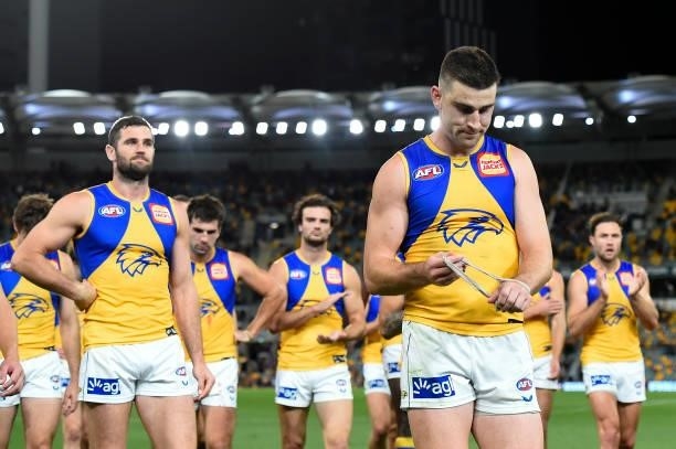 Elliott Yeo leads the West Coast Eagles walk off the field dejected after their defeat during the round 23 AFL match between the Brisbane Lions and...