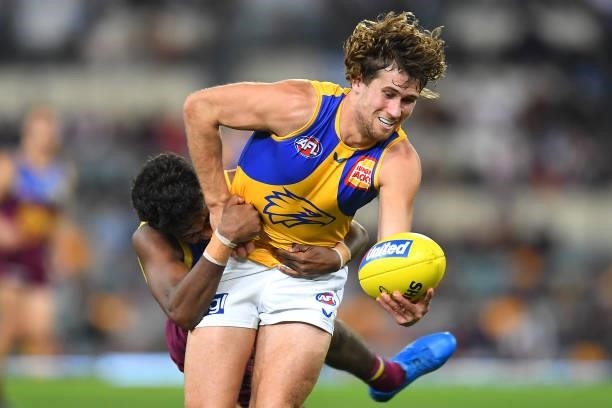 Connor West of the Eagles is tackled by Keidean Coleman of the Lions during the round 23 AFL match between the Brisbane Lions and the West Coast...