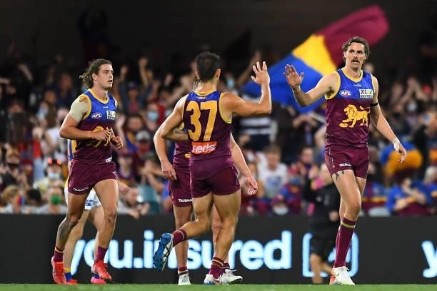 Joe Daniher of the Lions celebrates with team mates after kicking a goal during the round 23 AFL match between the Brisbane Lions and the West Coast...
